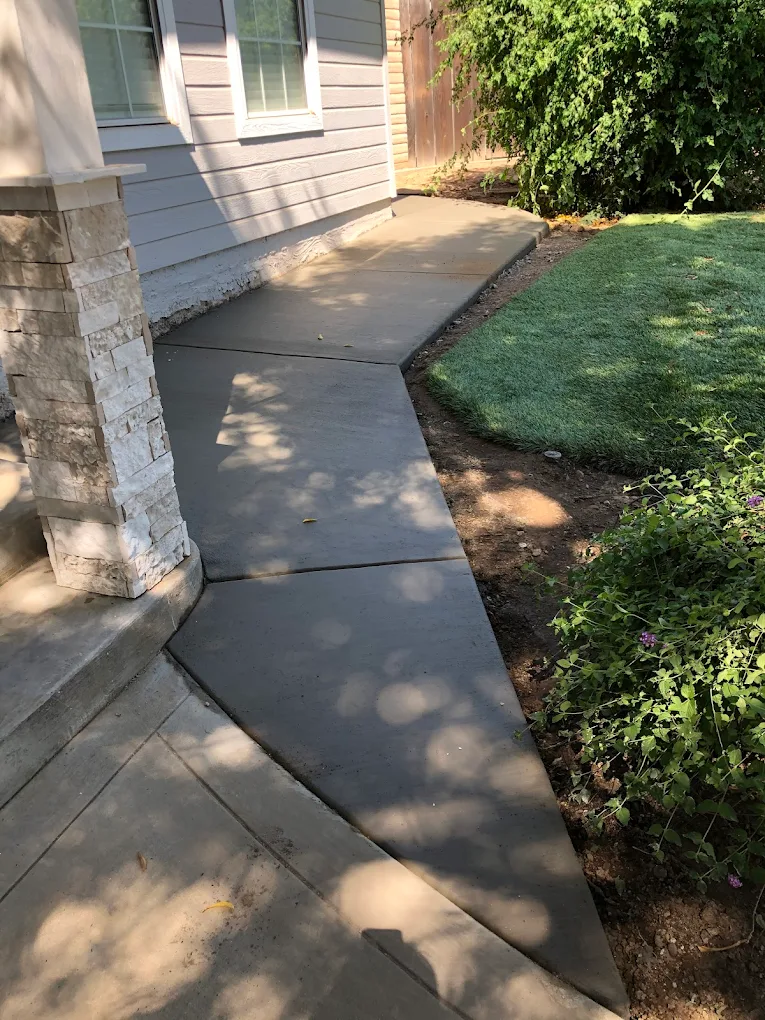 Custom concrete walkway path alongside house