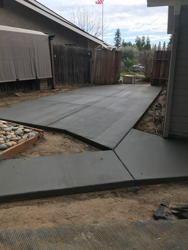 Concrete walkway and sidewalk along house in Sanger