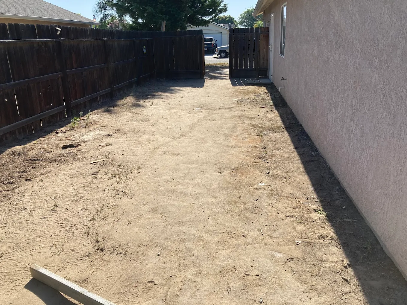 Before: bare dirt area before concrete driveway